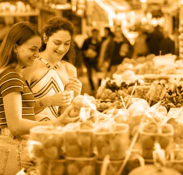 Three female students shopping in Swansea market