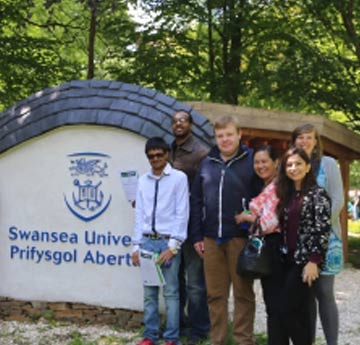 Image of Swansea University logo and group of people on Green Impact Award Ceremony