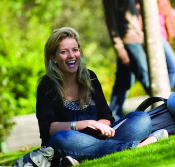 student sitting on grass