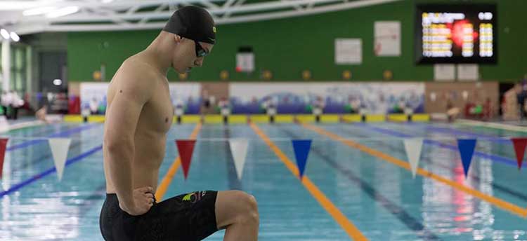 An image of Swansea Swansea University student and Sport Swansea swimming scholar Lewis Fraser getting ready to compete